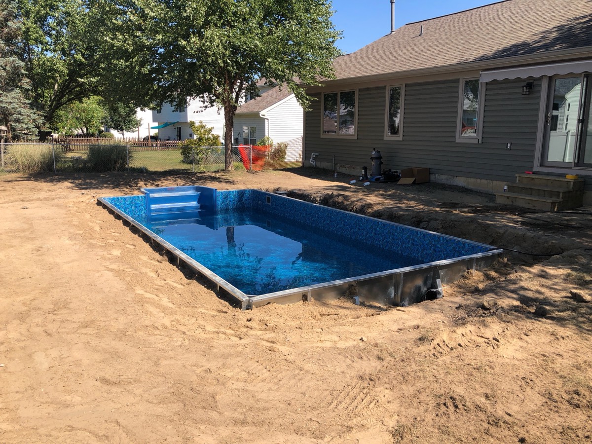 A Hydrosphere rectangle set fully inground during installation, before the deck