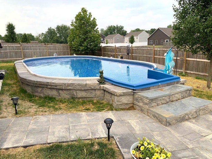 Hydrosphere Oval 15×30: semi-inground with stone veneer and steps