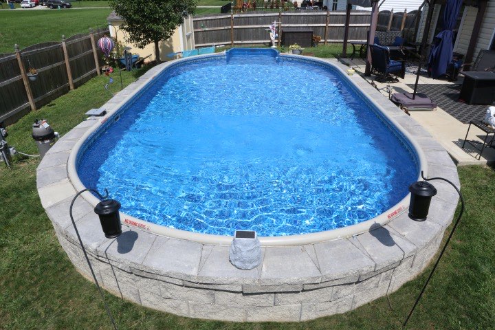 Hydrosphere Oval 15×30: semi-inground with stone veneer