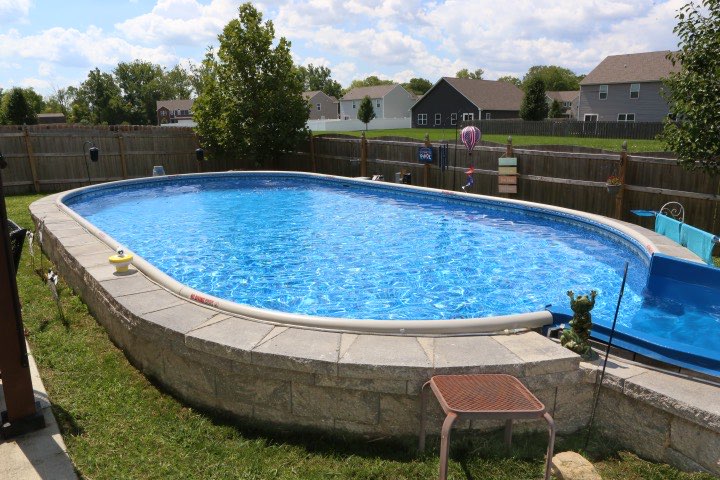 Hydrosphere Oval 15×30: semi-inground with stone veneer