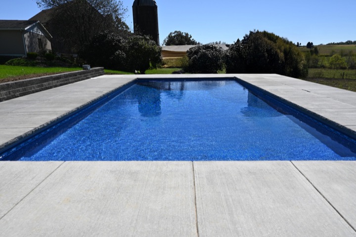 A long DB Trimax rectangle pool with a concrete deck